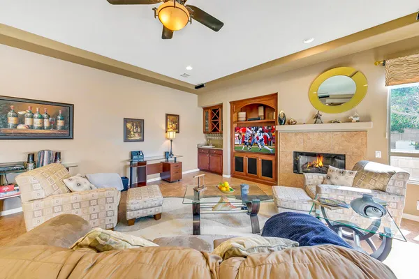 a living room with fireplace furniture and a flat screen tv