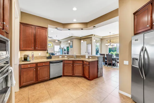 a large kitchen with stainless steel appliances lots of counter top space