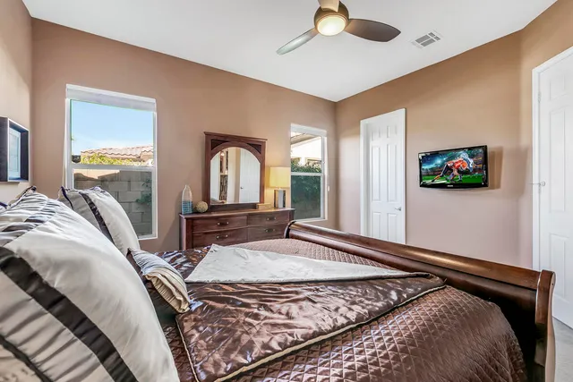 a bedroom with a bed and a flat screen tv