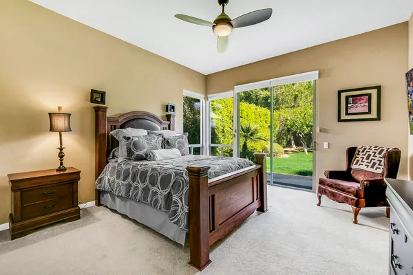 a bed room with a bed and a chair