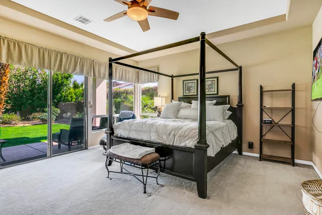 a bed sitting in a bedroom next to a yard