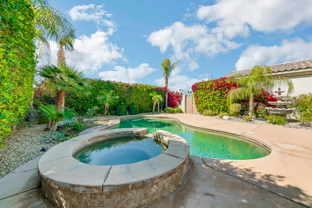 a view of a swimming pool with a yard