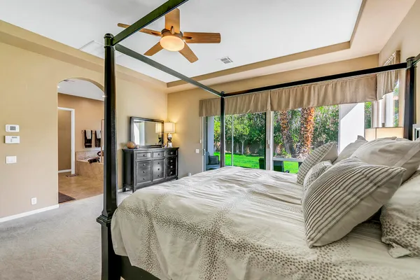 a bed sitting in a bedroom next to a large window