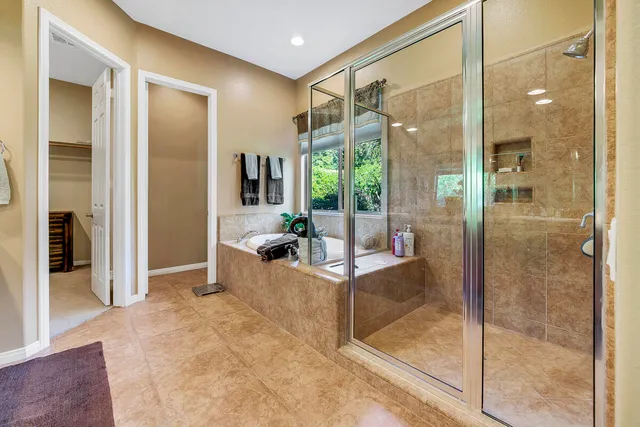 a living room with a glass door shower and fireplace