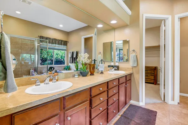 a bathroom with a sink double vanity and a shower