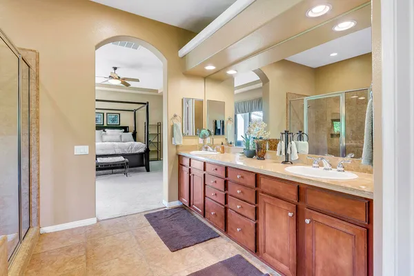a spacious bathroom with a double vanity sink and a mirror