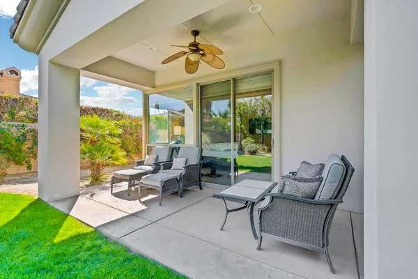a building outdoor space with patio furniture and garden