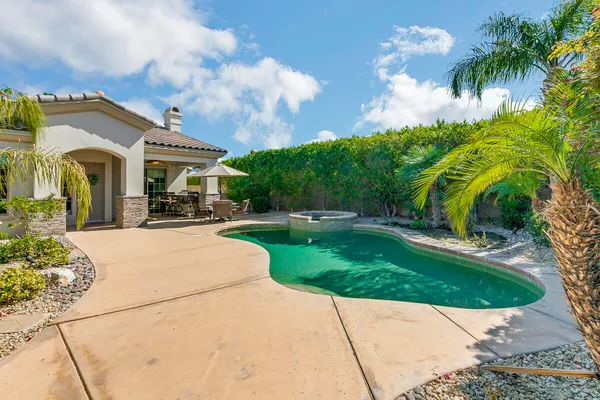 a view of a building with a garden and pathway