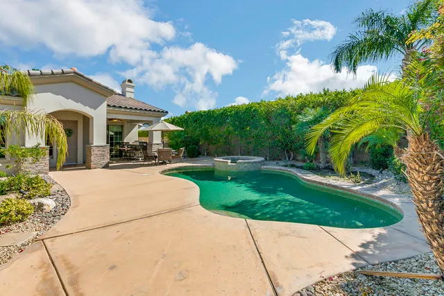a view of a building with a garden and pathway
