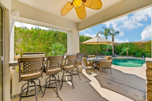a patio with yard glass top table and chairs