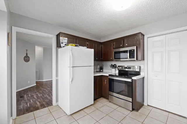 a kitchen with stainless steel appliances granite countertop a refrigerator stove and sink