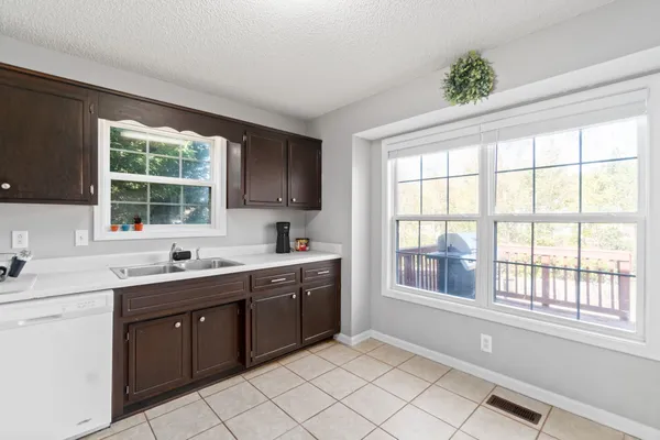 a kitchen with a sink window and cabinets