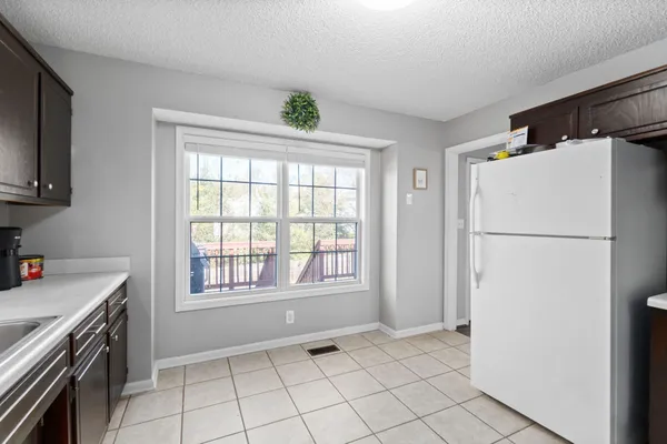 a view of a kitchen with a sink dishwasher and a refrigerator