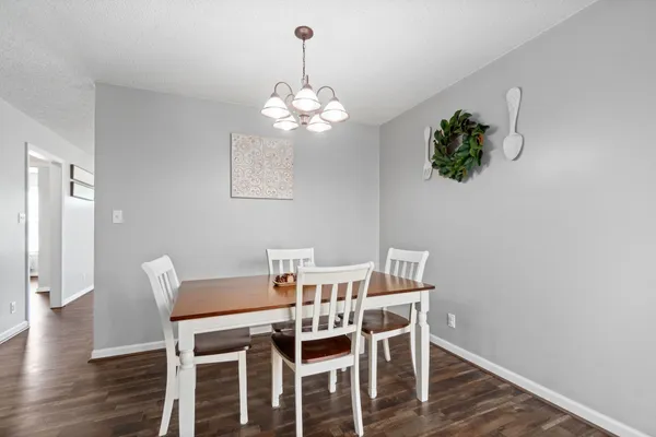 a view of a dining room with furniture wooden floor and chandelier