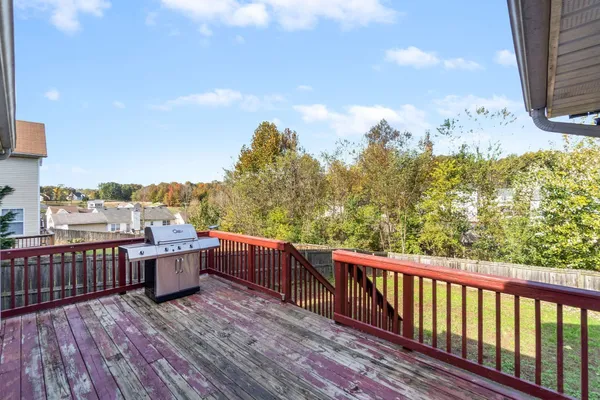 a view of roof deck with wooden floor and fence