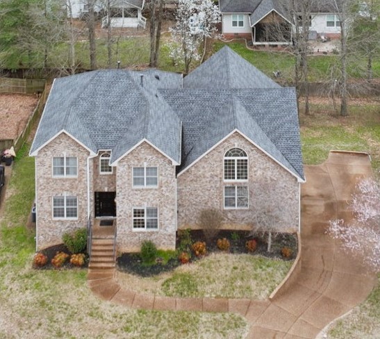 a aerial view of a house next to a yard