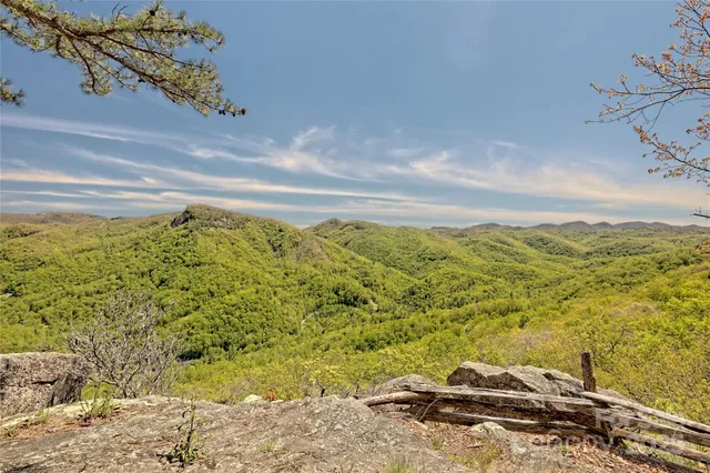 a view of a porch with furniture and a yard