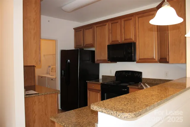 a kitchen with a refrigerator and a stove top oven