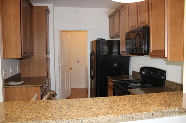 a kitchen with a refrigerator stove and cabinets