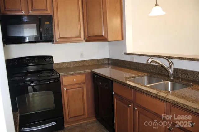 a kitchen with granite countertop a stove and a sink