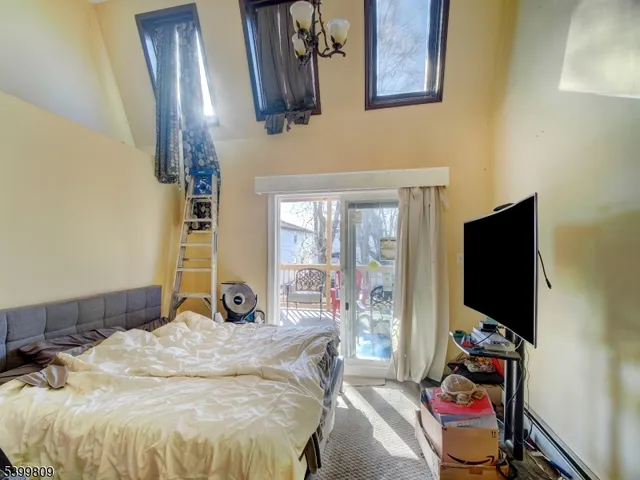 a living room with furniture a air conditioner vent and a window