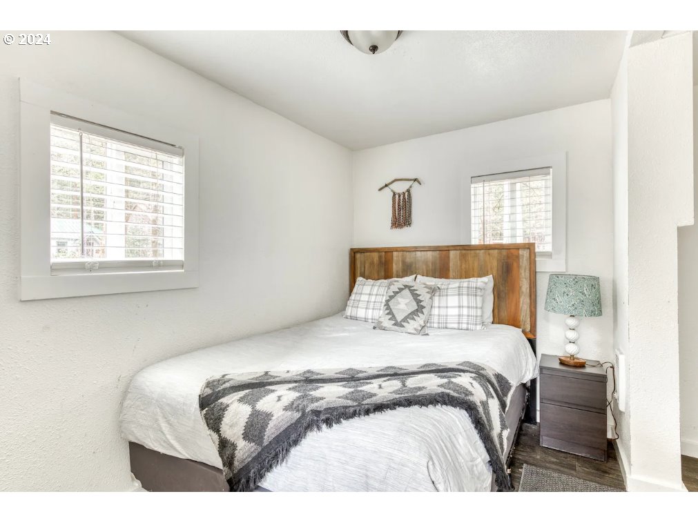 23795 East Lolo Pass Road Rhododendron, OR 97049 - Photo 12 of 19 a bedroom with a bed and a window