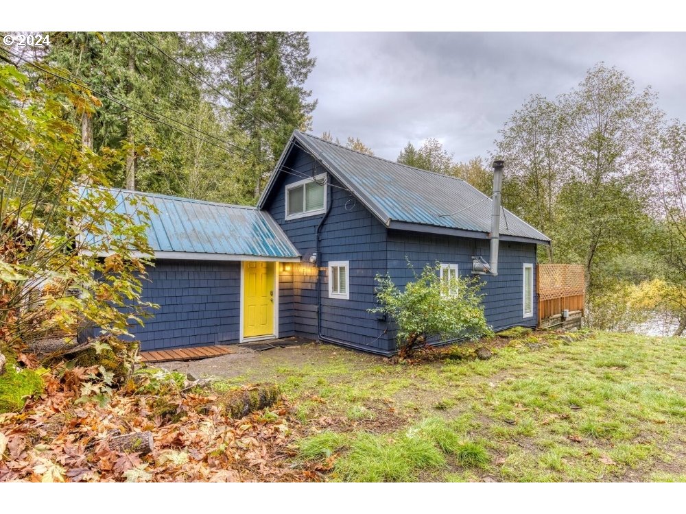 23795 East Lolo Pass Road Rhododendron, OR 97049 - Photo 19 of 19 a front view of a house with a yard