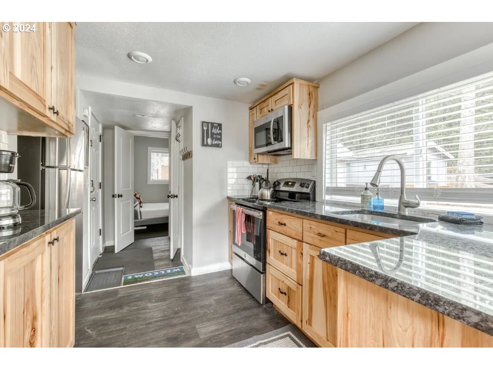 23795 East Lolo Pass Road Rhododendron, OR 97049 - Photo 10 of 19 a kitchen with stainless steel appliances granite countertop a sink stove and refrigerator