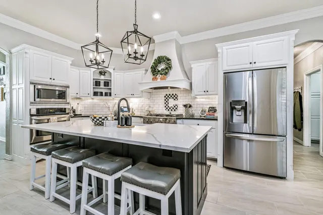 a kitchen with cabinets and stainless steel appliances
