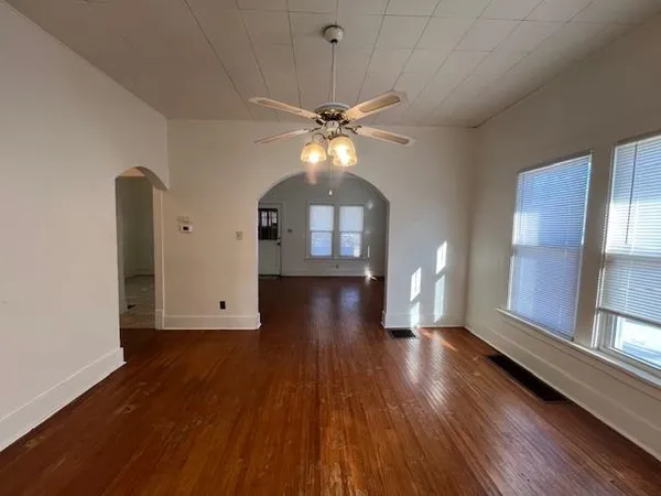 wooden floor in an empty room with a window