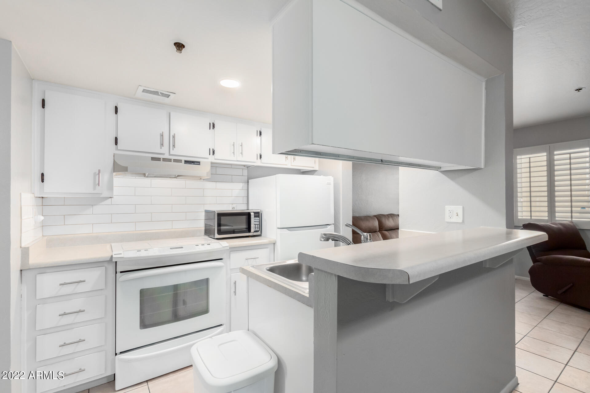 12123 West Bell Road, Unit 159 Surprise, AZ 85378 - Photo 1 of 21 a kitchen with a sink a stove and cabinets
