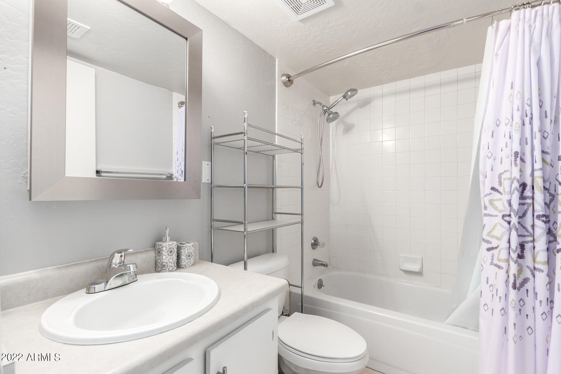 12123 West Bell Road, Unit 159 Surprise, AZ 85378 - Photo 11 of 21 a bathroom with a sink toilet and shower