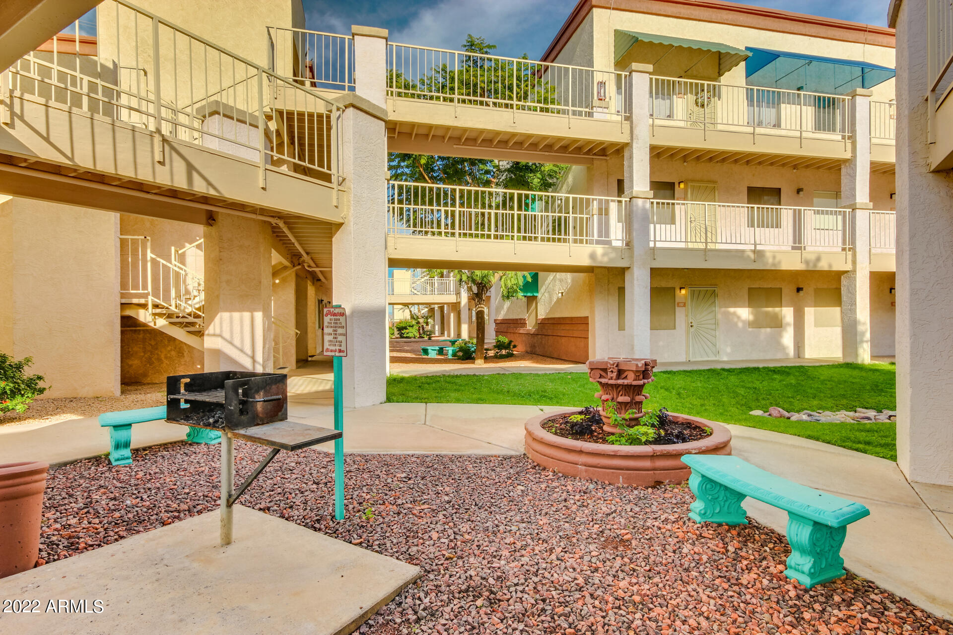 12123 West Bell Road, Unit 159 Surprise, AZ 85378 - Photo 17 of 21 a front view of a building with a garden and plants