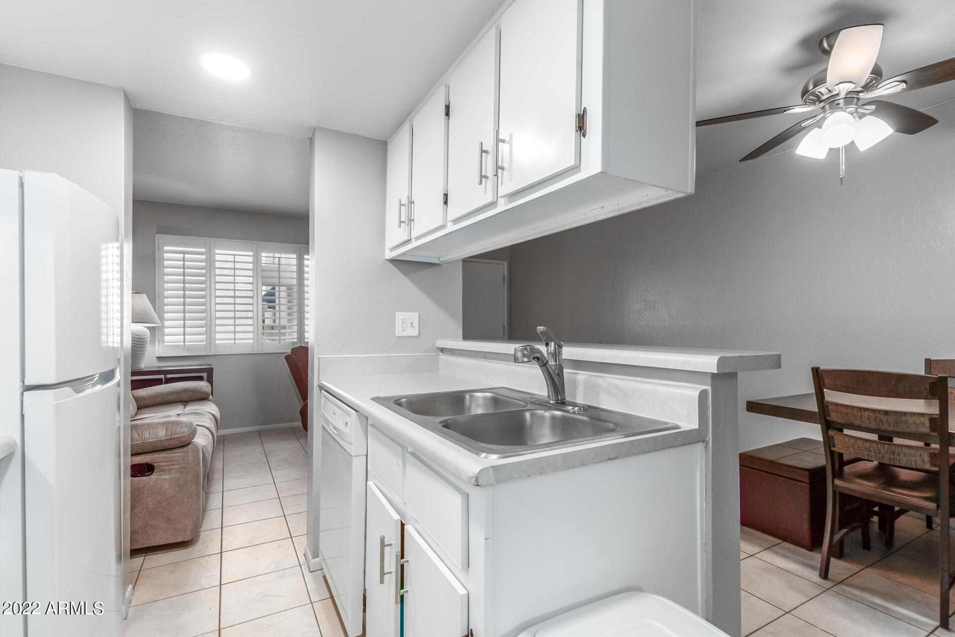 12123 West Bell Road, Unit 159 Surprise, AZ 85378 - Photo 3 of 21 a kitchen with stainless steel appliances granite countertop a sink and a refrigerator