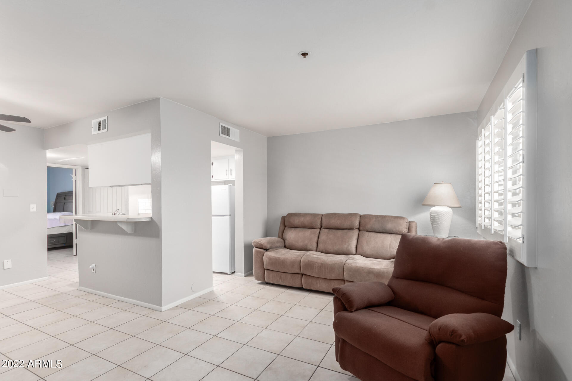 12123 West Bell Road, Unit 159 Surprise, AZ 85378 - Photo 4 of 21 a living room with furniture and a large window