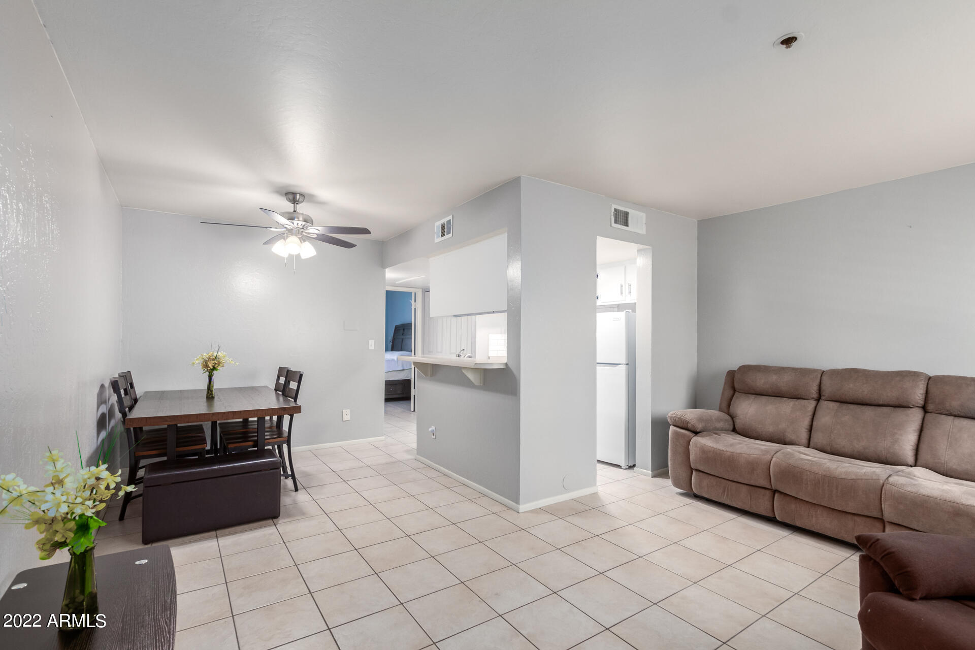12123 West Bell Road, Unit 159 Surprise, AZ 85378 - Photo 5 of 21 a living room with furniture and a chandelier