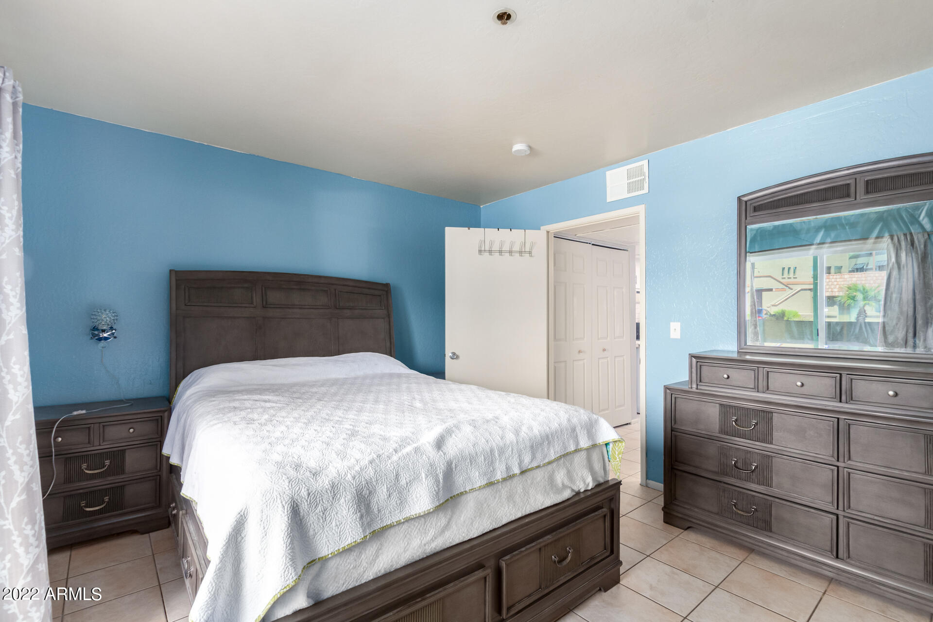 12123 West Bell Road, Unit 159 Surprise, AZ 85378 - Photo 10 of 21 a bedroom with a bed and a window