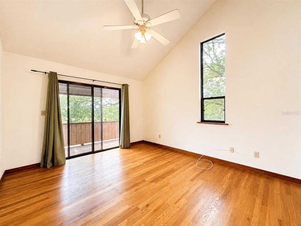 7119 Immokalee Road Keystone Heights, FL 32656 - Photo 29 of 50 an empty room with wooden floor and windows
