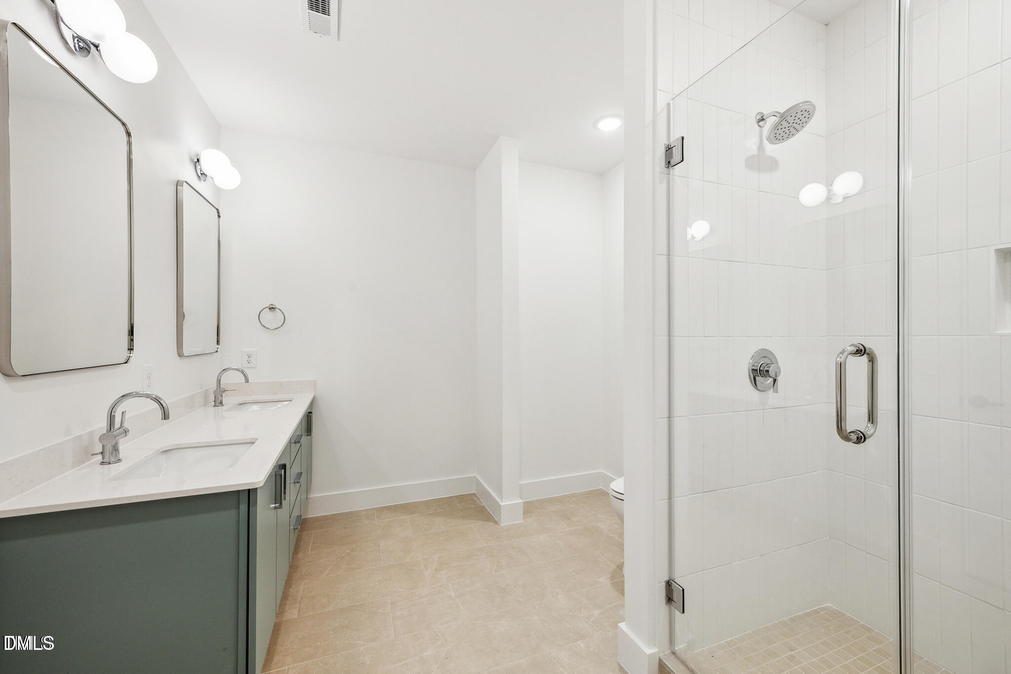 29 Enterprise Street, Unit 109 Raleigh, NC 27607 - Photo 12 of 18 a bathroom with a shower sink and mirror