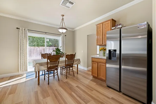 a dining room with furniture a chandelier and wooden floor