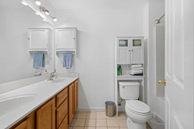 a bathroom with a sink toilet vanity and tub