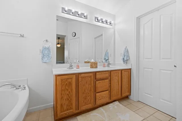a bathroom with a double vanity sink and a mirror