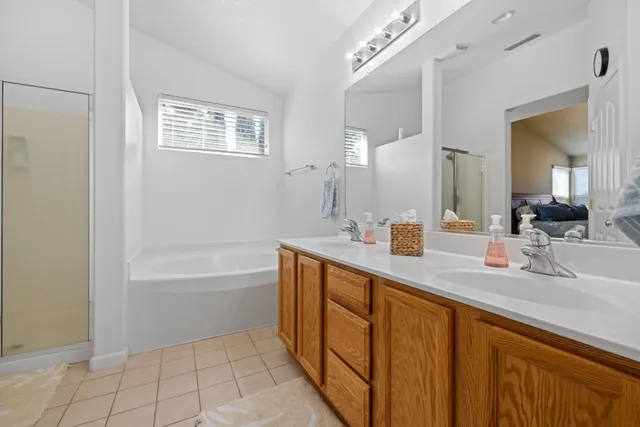 a spacious bathroom with a bathtub sink and mirror