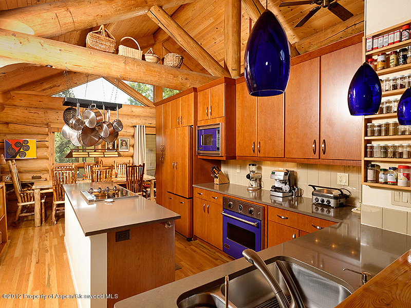 1637 Emma Spur Basalt, CO 81621 - Photo 6 of 35 a kitchen with stainless steel appliances granite countertop a sink a stove and a wooden cabinets