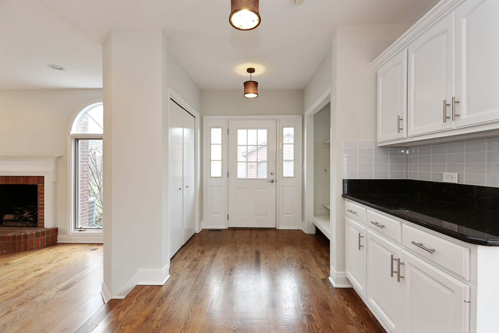 330 Radcliffe Way Hinsdale, IL 60521 - Photo 17 of 27 wooden floor in an empty room with a kitchen and a window
