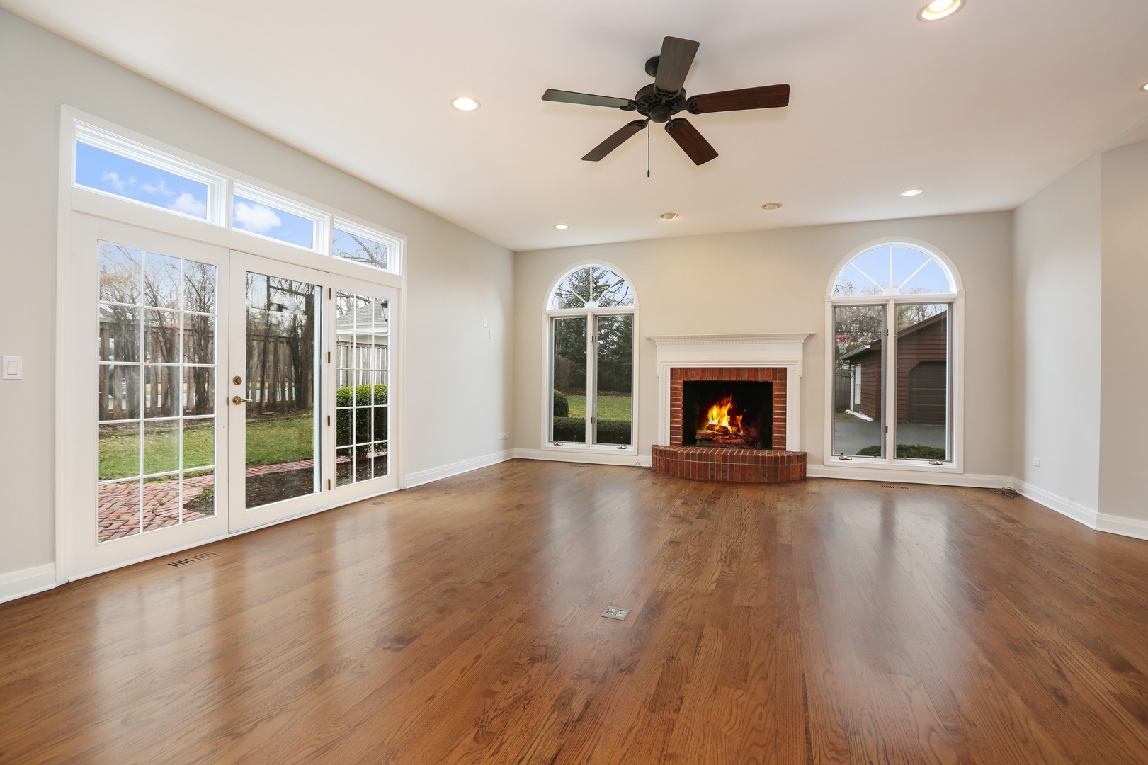 330 Radcliffe Way Hinsdale, IL 60521 - Photo 20 of 27 a view of an empty room with wooden floor and a fireplace