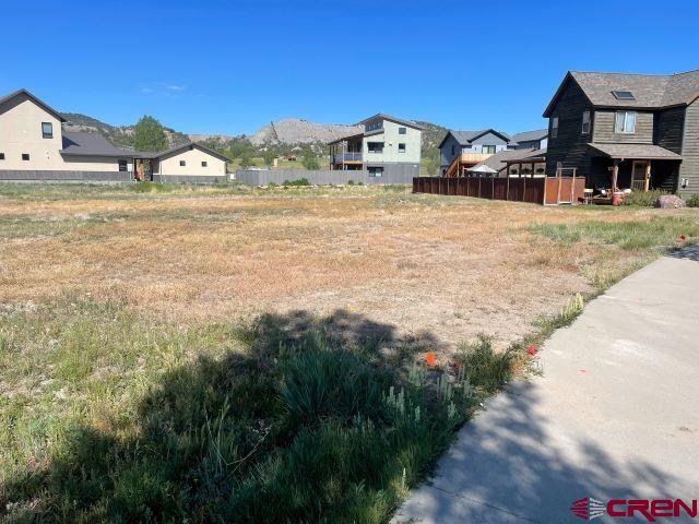 413 Kismet Street Ridgway, CO 81432 - Photo 3 of 9 a view of a car park next to a road with big house