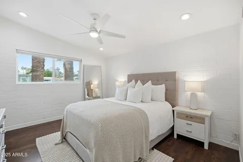 a bedroom with a large bed and a chandelier