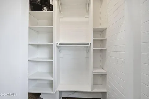a close view of walk in closet with empty racks