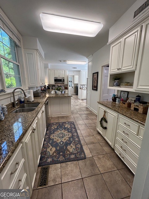 1156 South Main Street Moultrie, GA 31768 - Photo 23 of 56 a kitchen with sink a stove and cabinets